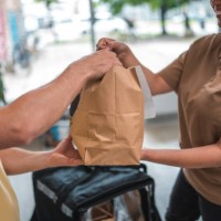 seamless meal service for a mid adult male employee in a modern office - junk food stock pictures, royalty-free photos & images