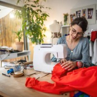 seamstress working on sewing machine - fashion stock pictures, royalty-free photos & images
