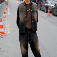 Selena Forrest wears brown faded denim jacket with matching jeans, brown t-shirt, white Nike sneakers, outside Chanel, during the Womenswear...