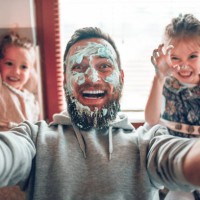 selfie by father with cute child daughters after cooking and making mess with topping - food stock pictures, royalty-free photos & images