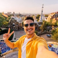 selfie of a young smiling man in sunglasses in barcelona, spain - travel stock pictures, royalty-free photos & images
