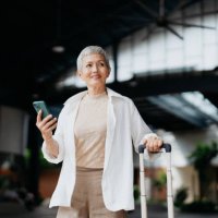 senior asian female business traveller using smartphone - travel stock pictures, royalty-free photos & images