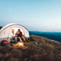 senior couple camping in the mountains and eating a snack - travel stock pictures, royalty-free photos & images