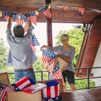 senior couple decorating outdoor deck - garden decoration stock pictures, royalty-free photos & images