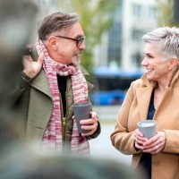 senior couple enjoying coffee to go and talking - junk food stock pictures, royalty-free photos & images