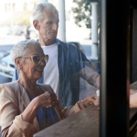 senior couple ordering coffee to-go, at street bakery - junk food stock pictures, royalty-free photos & images