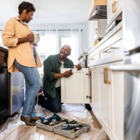 senior couple repairing kitchen cabinet at home - home decoration stock pictures, royalty-free photos & images