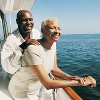 senior couple standing on deck on a boat looking at the view - travel stock pictures, royalty-free photos & images
