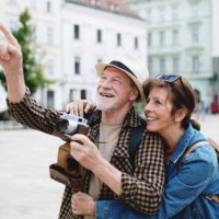 senior couple travelers sightseeing in city. - travel stock pictures, royalty-free photos & images