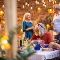 senior friends enjoying dinner party at backyard - garden decoration stock pictures, royalty-free photos & images