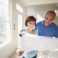 senior hispanic couple looking at blueprints in new house - home decoration stock pictures, royalty-free photos & images