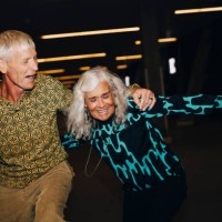 senior man and woman dancing in parking garage - fashion stock pictures, royalty-free photos & images