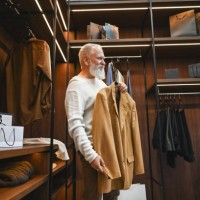 senior man buying clothes at department store. - fashion stock pictures, royalty-free photos & images