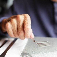 senior man holding fork at restaurant table - food stock pictures, royalty-free photos & images