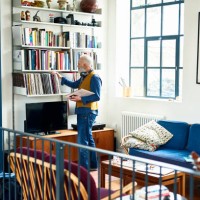 senior man sorting through his record collection in living room - home decoration stock pictures, royalty-free photos & images