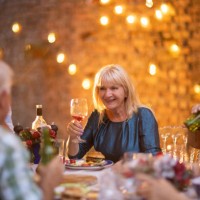 senior woman enjoying fun time with her friends on dinner party at backyard - garden decoration stock pictures, royalty-free photos & images