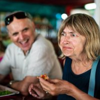 senior woman tries a new dish in a restaurant. - food stock pictures, royalty-free photos & images