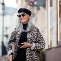 senior woman with extravagant clothes walking outdoors in town. - fashion stock pictures, royalty-free photos & images