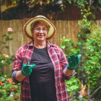 senior woman with flowers in garden - garden decoration stock pictures, royalty-free photos & images