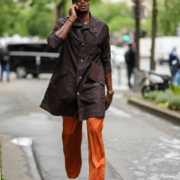 Serge Ibaka wears a black cap, black sunglasses, a white t-shirt, a dark brown long shirt, a gold Juste Un Clou bracelet from Cartier, a silver...