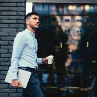 serious businessman walking at the city street - junk food stock pictures, royalty-free photos & images