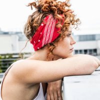 serious redheaded woman leaning on wall - hairstyle stock pictures, royalty-free photos & images
