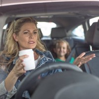 serious woman and girl in car - junk food stock pictures, royalty-free photos & images