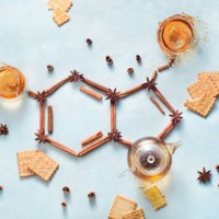 serotonin molecule made out of cinnamon and teacups with splashes. creative drink flat lay with the hormone of joy. - food stock pictures, royalty-free photos & images