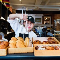 service at the counter for owner of a small bakery shop. - food stock pictures, royalty-free photos & images