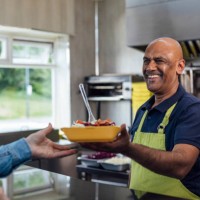 serving a customer at a takeaway shop - junk food stock pictures, royalty-free photos & images