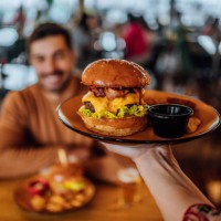 serving burger - junk food stock pictures, royalty-free photos & images