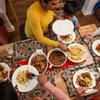 serving dinner to her family - food stock pictures, royalty-free photos & images