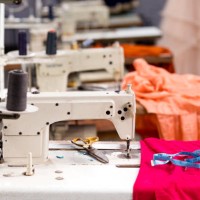 sewing or tailoring industrial hall with machinery - fashion stock pictures, royalty-free photos & images