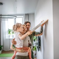 shared family tasks: decorating and moving into a new apartment as a team - home decoration stock pictures, royalty-free photos & images