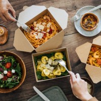 sharing takeaway meal on dining table - food stock pictures, royalty-free photos & images