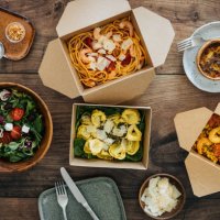 sharing takeaway meal on dining table - junk food stock pictures, royalty-free photos & images