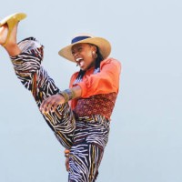 shot of a beautiful young woman having fun against an blue wall - fashion stock pictures, royalty-free photos & images