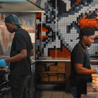 shot of a chef preparing food in a commercial kitchen at a restaurant - junk food stock pictures, royalty-free photos & images