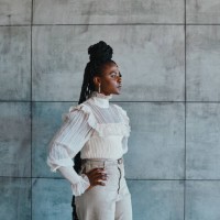 shot of a stylish young woman posing against a concrete wall - fashion stock pictures, royalty-free photos & images
