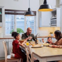 shot of a young family enjoying a meal together - food stock pictures, royalty-free photos & images