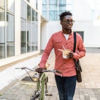 shot of a young man using a bicycle outdoors - junk food stock pictures, royalty-free photos & images