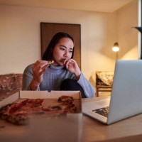 shot of a young woman having pizza while working from home - junk food stock pictures, royalty-free photos & images