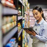 shot of a young woman using a tablet at work in a supermarket - food stock pictures, royalty-free photos & images