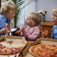 siblings eating pizza together - junk food stock pictures, royalty-free photos & images
