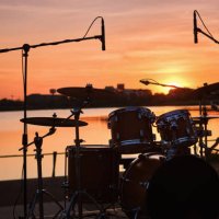 silhouette drum kit by the lake - concert stock pictures, royalty-free photos & images