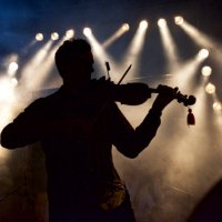 silhouette of a man on stage playing the violin - concert stock pictures, royalty-free photos & images