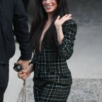 Singer and songwriter Camila Cabello waves as she arrives to attend the presentation by Chanel for the Womenswear Ready-to-wear Fall-Winter 2025/2026...