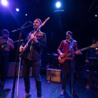 singer closing his eyes while performing onstage with band - concert stock pictures, royalty-free photos & images