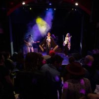 singer wearing cape performing on stage with band - concert stock pictures, royalty-free photos & images