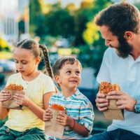 single father with kids eating fast food outside - junk food stock pictures, royalty-free photos & images